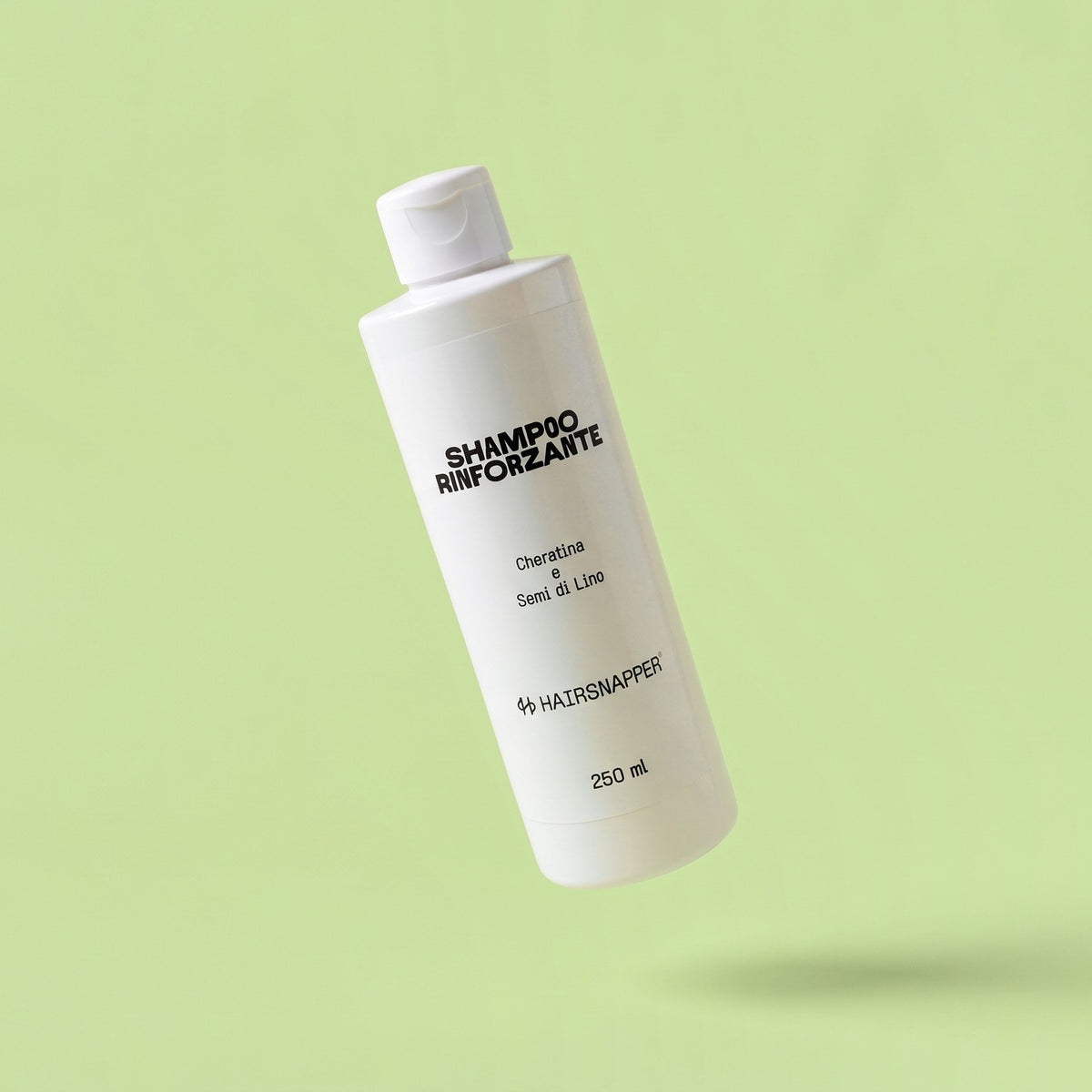 HairSnapper Shampoo Rinforzante 250 ml sospeso su fondo pistacchio