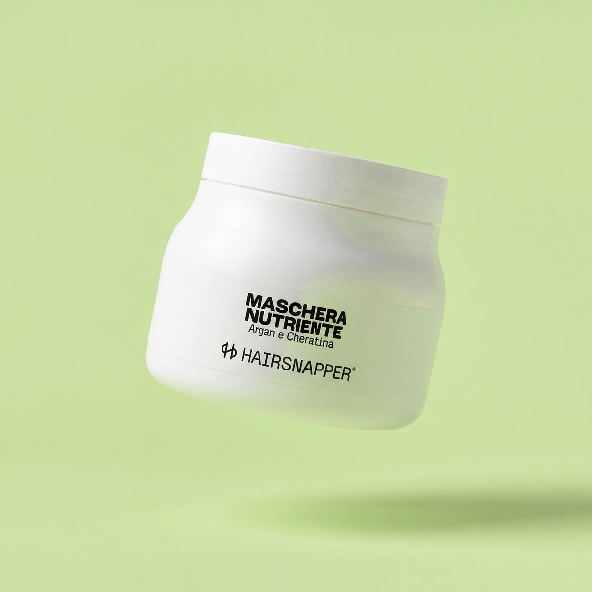 HairSnapper Maschera Nutriente 500 ml sospesa su fondo pistacchio